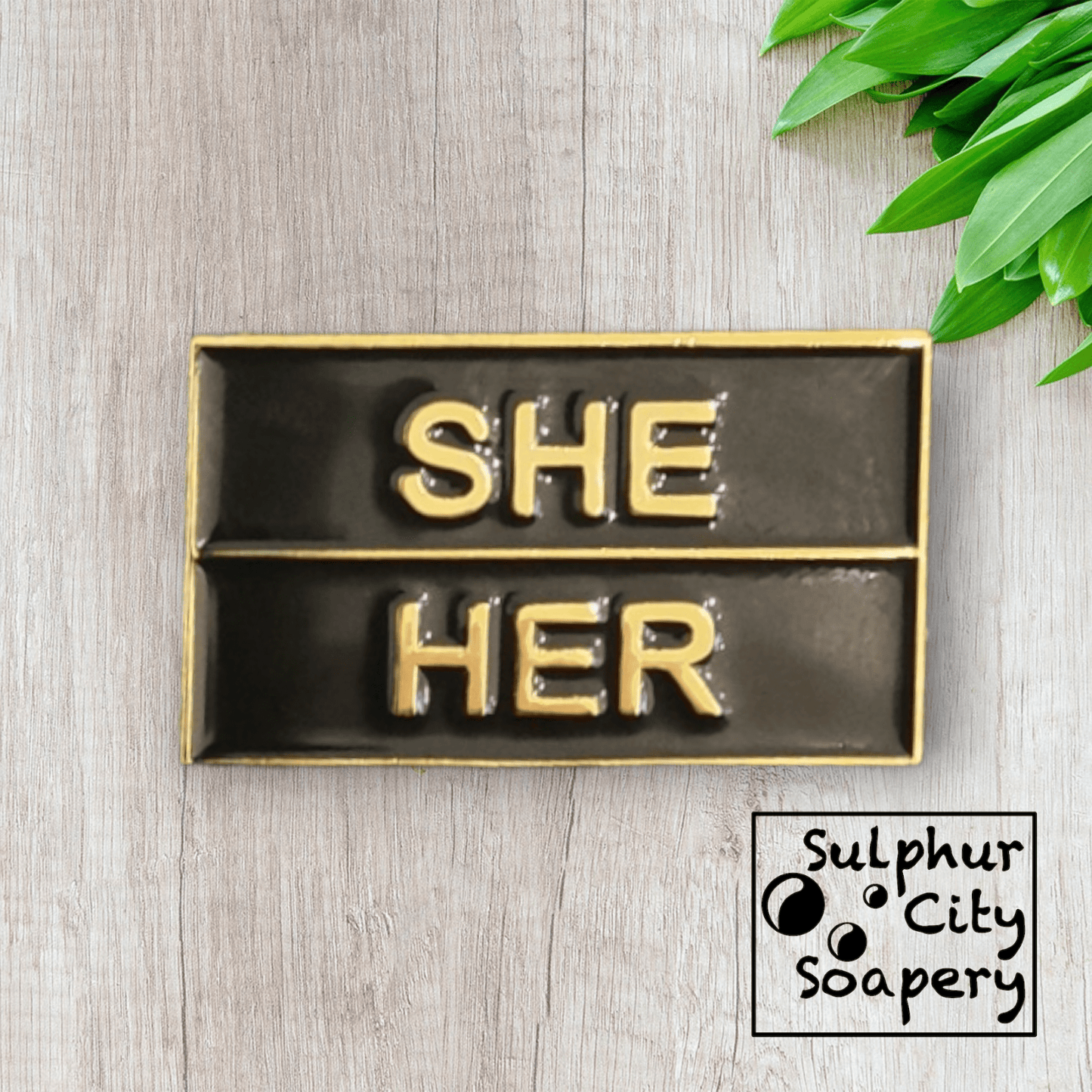 Sulphur City Soapery pronoun pin Pronoun pin in black and gold -  She / Her