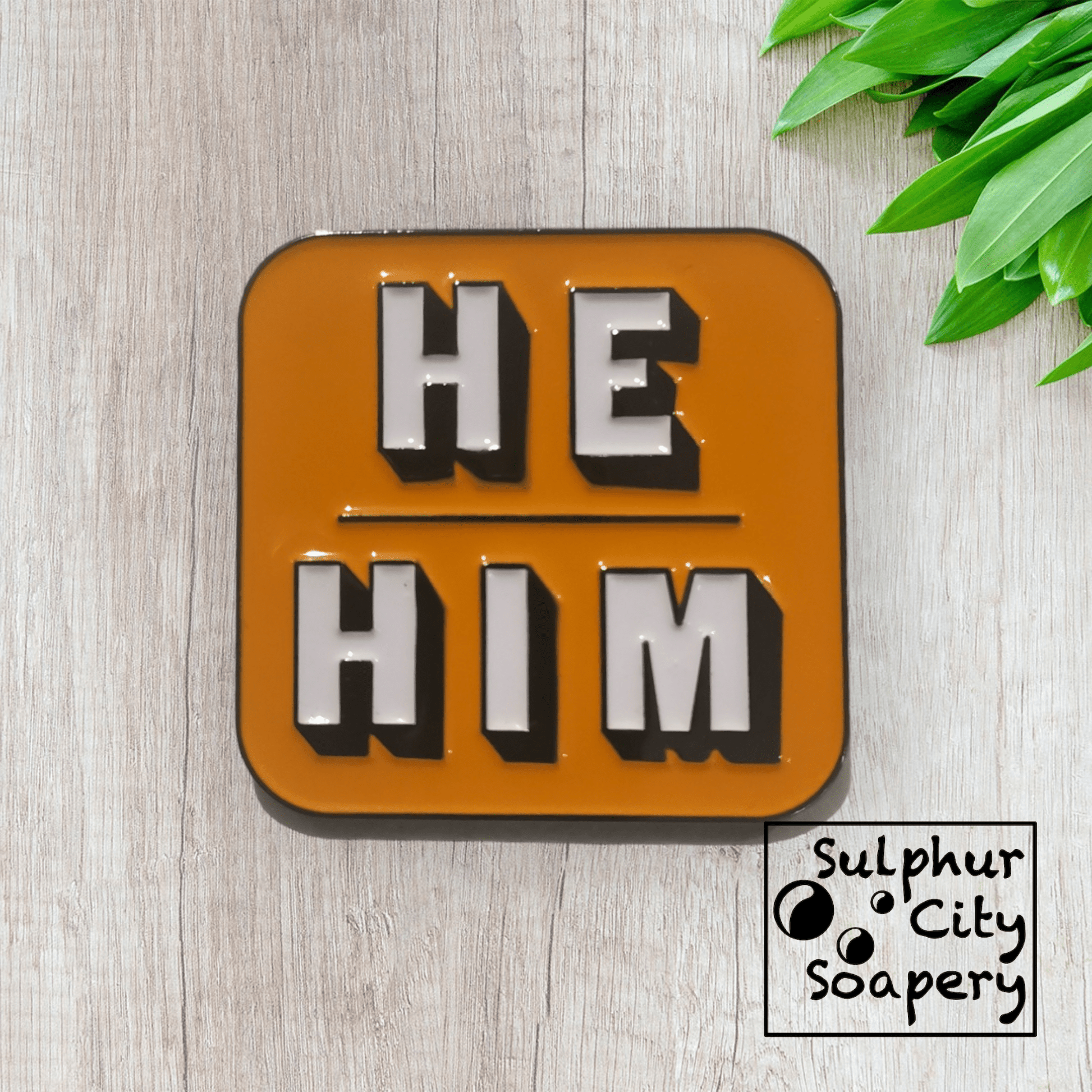 Sulphur City Soapery pronoun pin Pronoun pin in black and orange -  He / Him